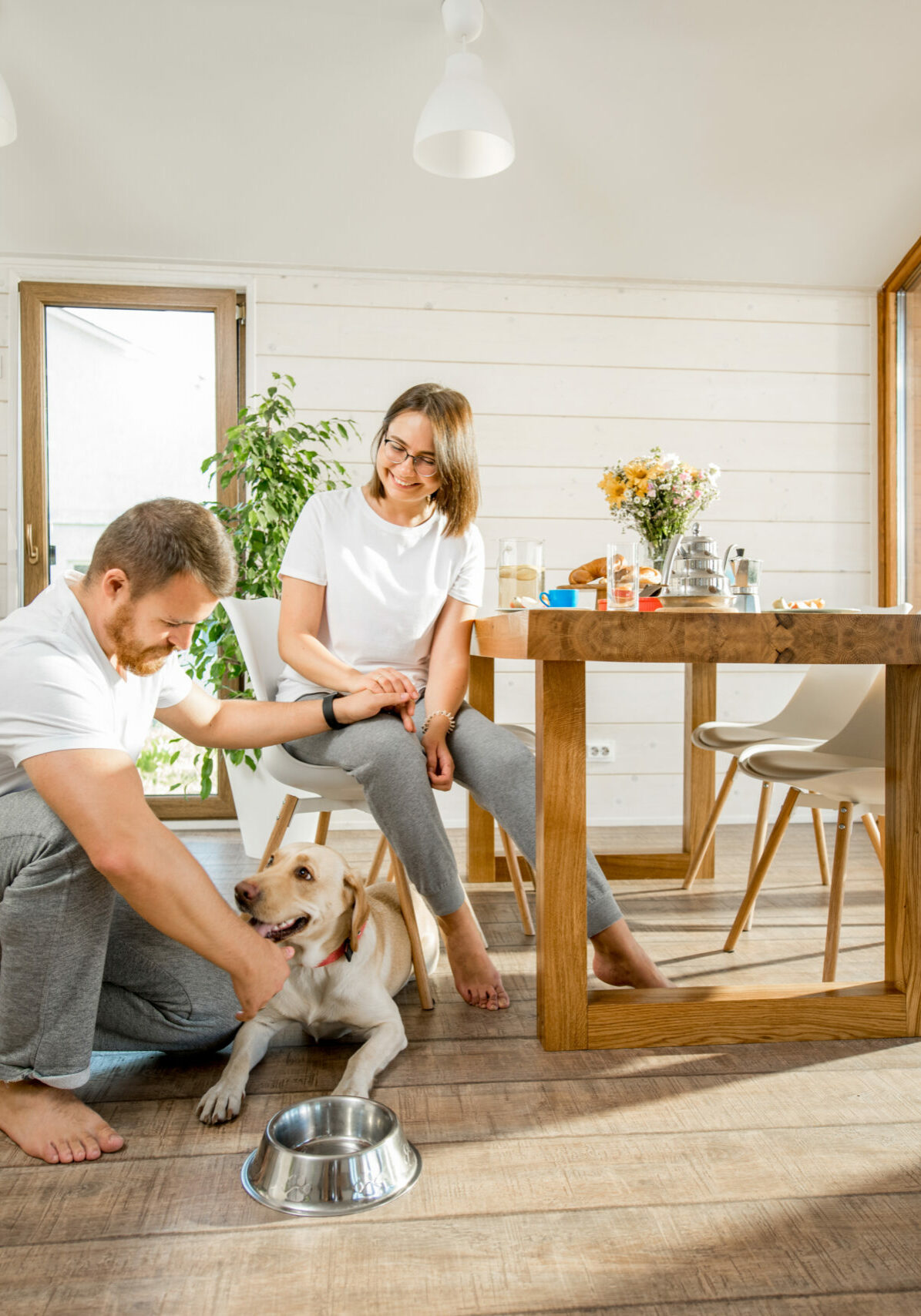 Young couple with dog at home | Floor to Ceiling Grand Island